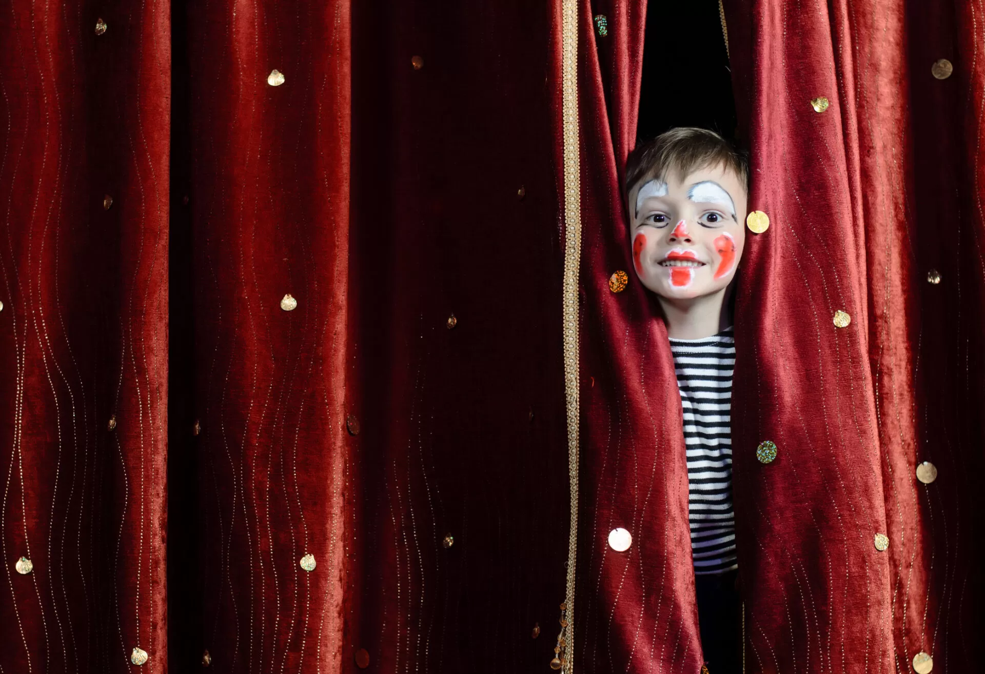 Boy Clown Peering Through Stage Curtains