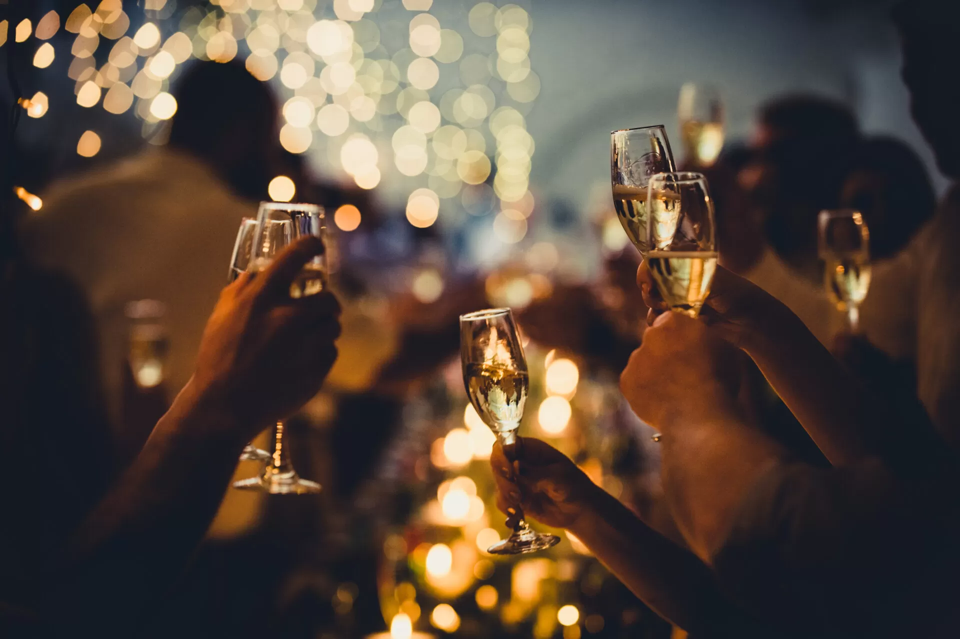 Wedding Celebratory Toast with String Lights and Champagne Silhouettes