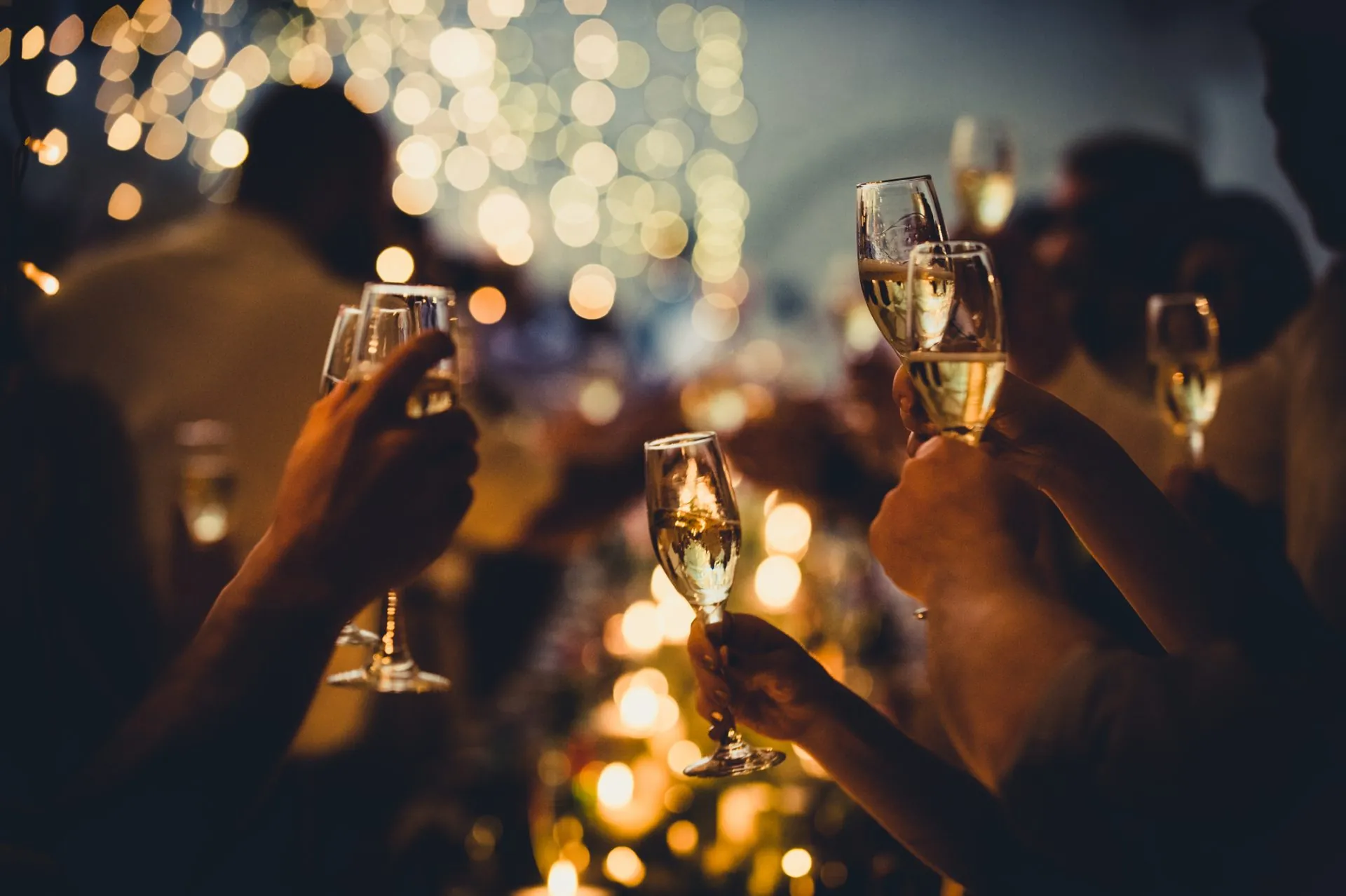 Wedding Celebratory Toast with String Lights and Champagne Silhouettes